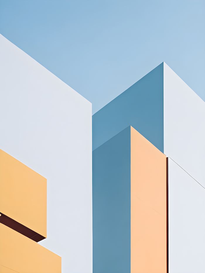 creative-01 A clean, minimalist architectural facade featuring bold geometric shapes in pastel hues against a clear sky.
